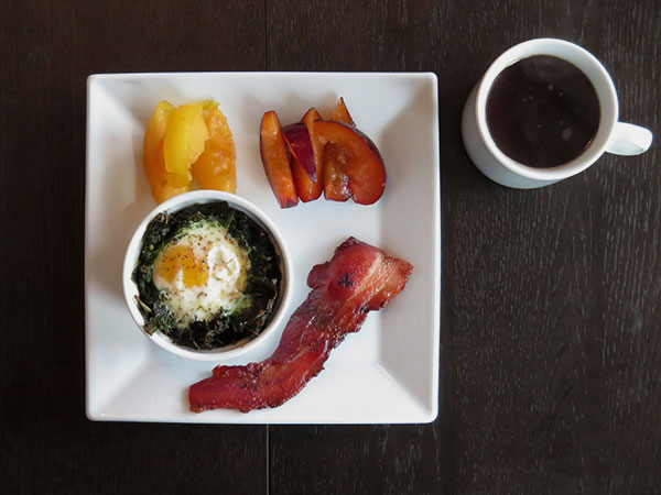 Baked Eggs with Kale, Einka & Lentils Served with Bacon and Fresh Plums