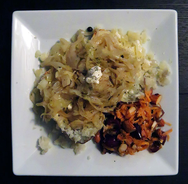 Baked Potato Topped With Juniper-Braised Cabbage and Served With Carrot-Olive Salad
