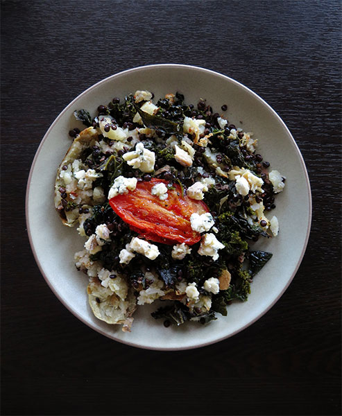 Baked Potato Topped With Sautéed Kale and Black Lentils, Slow-Roasted Tomatoes, and Blue Cheese