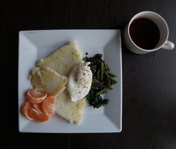 Fried Leftover Grits and Greens Served with Poached Eggs and Mandarins