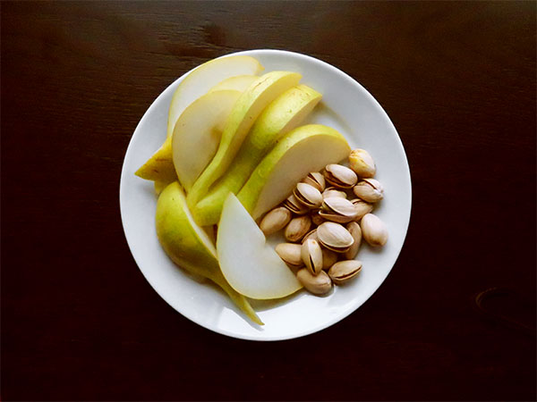 Sliced Concorde Pears and Roasted Pistachio Nuts in the Shell