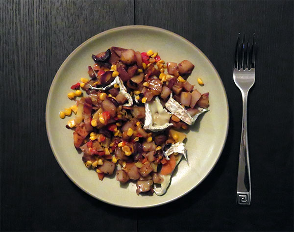 Pan-Fried Potatoes, Rainbow Carrots, and Onions Topped with Creamed Corn, Braised Peppers and Seastack Cheese