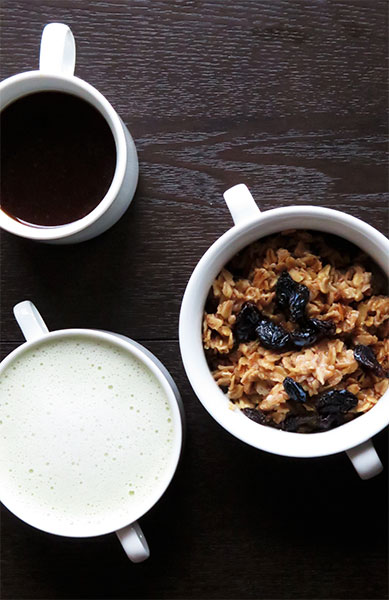 Rolled Oats Topped With Cinnamon and Raisins, With a Matcha Latte and Coffee