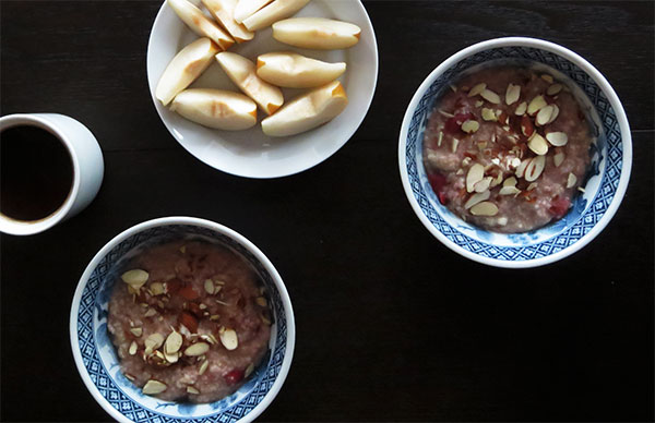 Scottish Oatmeal Made With Frozen Sour Cherries and Garnished With Sliced Almonds