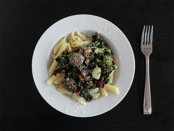 Penne Pasta With Braised Vegetables, Greens, Bratwurst, Wheat Berries and Roasted Garlic