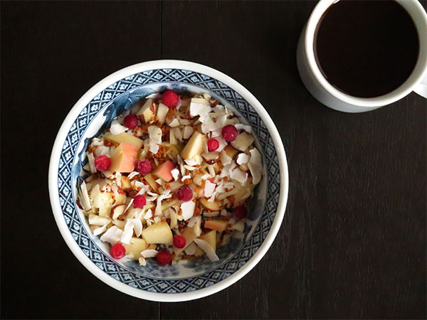 Plain Yogurt Topped With Apples, Chia Seeds, Brazil Nuts, Coconut Flakes and Bee Pollen